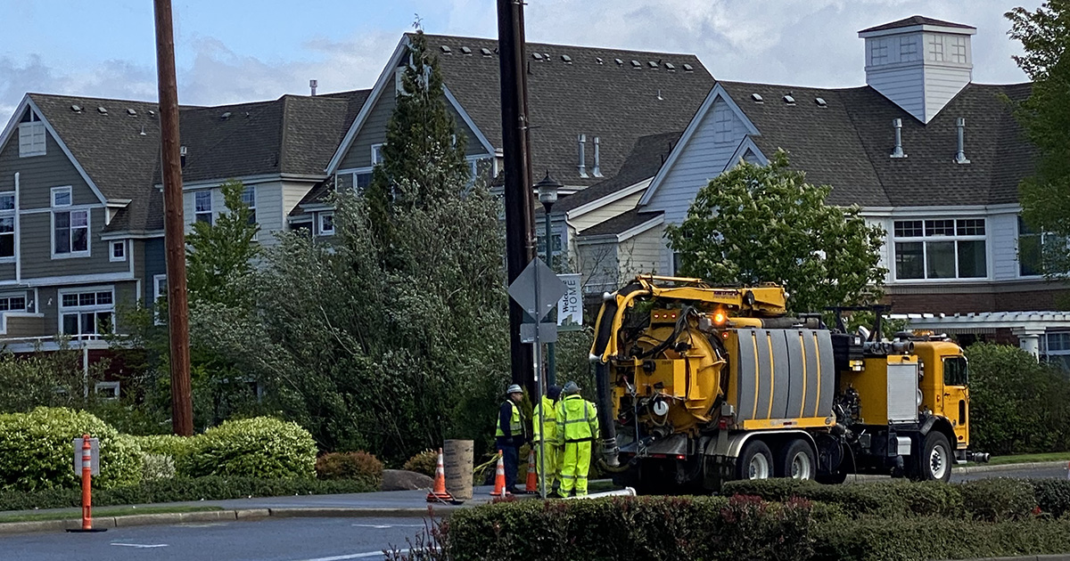 A crew from the City of Issaquah Public Works Department works to install flashing crosswalk beacons on Northeast Park Drive.